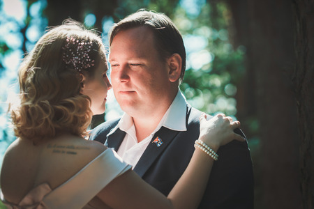 bride and groom on the background of trees and forest sun. Stock Photo