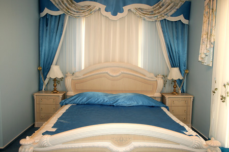 Nice blue bedroom with many luxurious details.