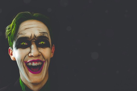 Cosplay of a cult character from comics joker laughs in the dark halloween holidays copy space for text