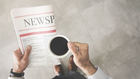 Man reading newspaper high angle view