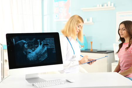 Computer with ultrasound scan with doctor and patient on background Stock Photo