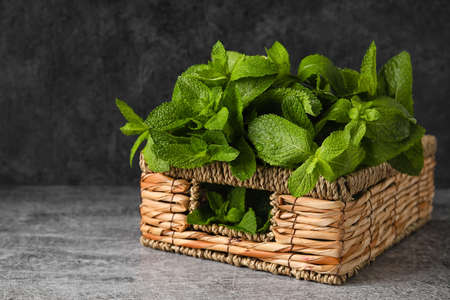 Wicker basket with mint on table