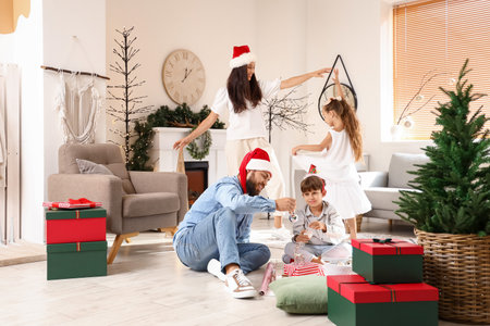 Happy family with cute little children celebrating christmas at home Stock Photo Happy family with cute little children celebrating christmas at home Stock Photo