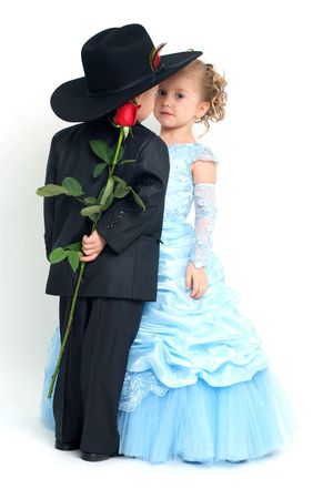 Lovely girl and boy hiding a rose behind his back Фото со стока