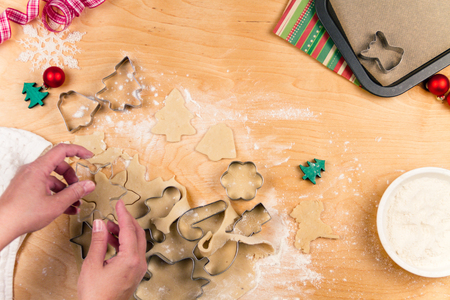 making christmas cookies with different shapes of cookie cutters stock photo - Making Christmas Cookies making christmas cookies with different shapes of cookie cutters stock photo - Making Christmas Cookies