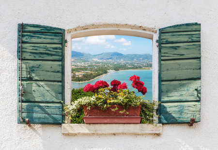 Sea view through the open window with flowers in Italy Фото со стока