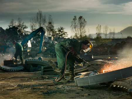 workers welding metal outdors Фото со стока