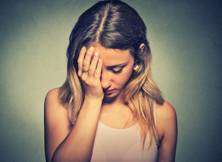 sad lonely: problems. Sad woman isolated on gray wall background