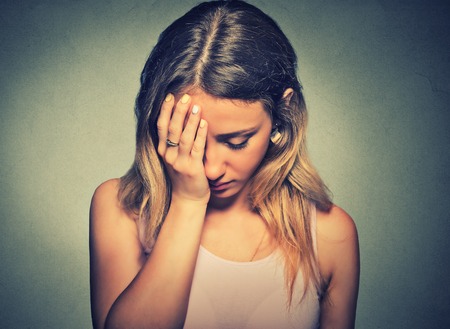 problems. Sad woman isolated on gray wall background - 55030229