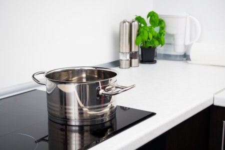 Pot and vegetables in modern kitchen with induction stove royalty ... Konyha lap