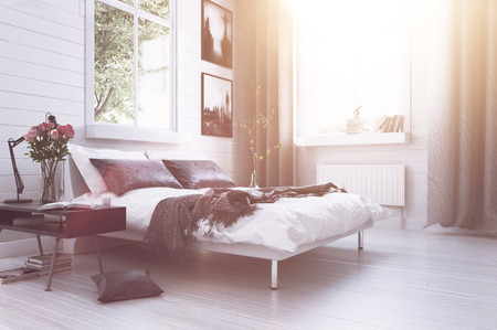 Warm sunlight with sun flare in a modern luxury bedroom with a double divan bed, flowers, artwork on the walls and long drapes in grey and white decor