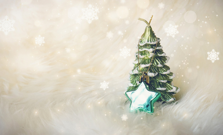 small christmas tree with a green star on white fur surrounded with glitter star dust - White Mini Christmas Tree small christmas tree with a green star on white fur surrounded with glitter star dust - White Mini Christmas Tree