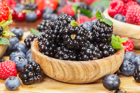 blackberries fresh blackberries in an olive wood bowl and