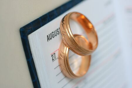 calendar and wedding rings for planning the wedding stock photo