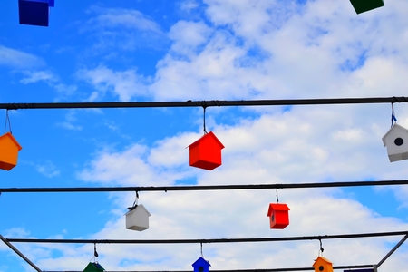 Colorful nesting boxes on blue sky.
