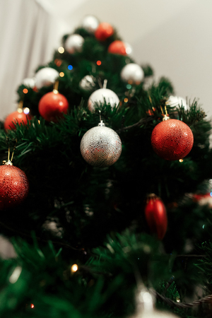 close up of colorful red and silver christmas ornaments on christmas tree with lights - Red And Silver Christmas Ornaments close up of colorful red and silver christmas ornaments on christmas tree with lights - Red And Silver Christmas Ornaments