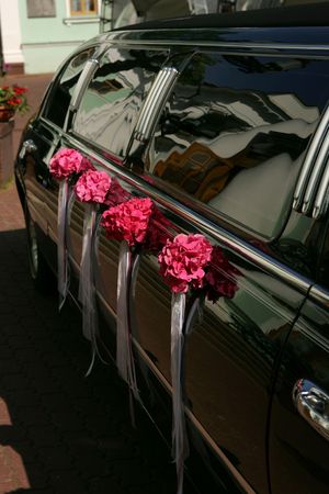 Luxurious black stretch limousine decorated with flowers Фото со стока