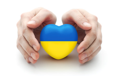 Hands covering Ukrainian heart on white background Reklamní fotografie