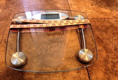 Scale to monitor weight with a measuring tape to take measurements to keep track of physical fitness