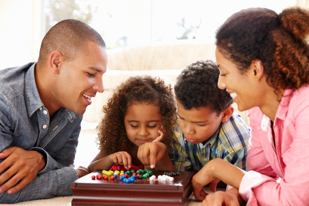 Mixed race family playing solitaire - 42109255