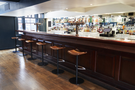 interior of empty bar with stools and counter stock photo picture