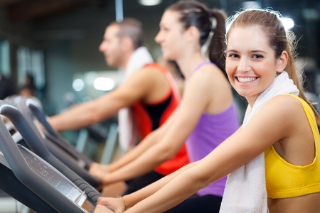 Group of young active people doing fitness in a gym Фото со стока