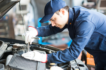 portrait of an auto mechanic at work on a car in his garage stock motor mechanic