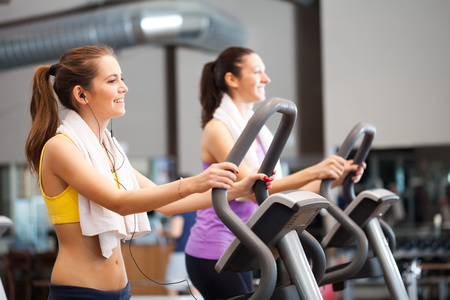 Two women training in a gym Фото со стока