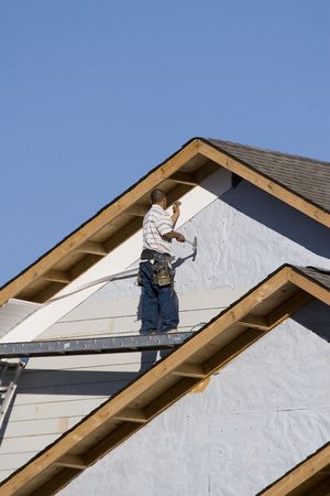 vinyl siding being installed on a new homw under contruction stock