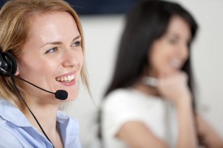 Two colleagues working in a busy call centre office. Stockfoto