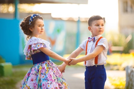 Cute boy and girl holding hands. Valentine's Day. Love story - 66088205