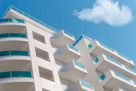 Balconies and blue sky with clouds. part of a residential building in turkey. modern apartment buildings on a sunny day. architectural details.