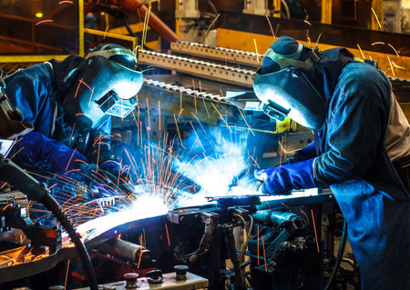 worker with protective mask welding metal - 33970898