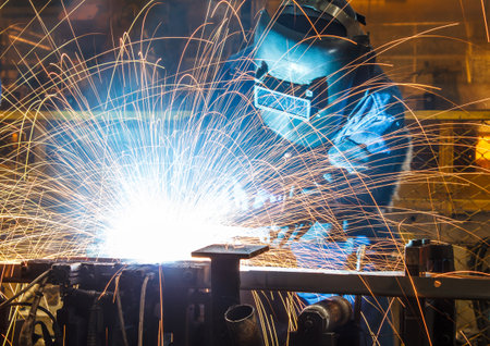 worker with protective mask welding metal - 44962484