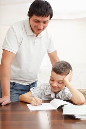 father helping son do homework parent helps his child stock photo parent helps