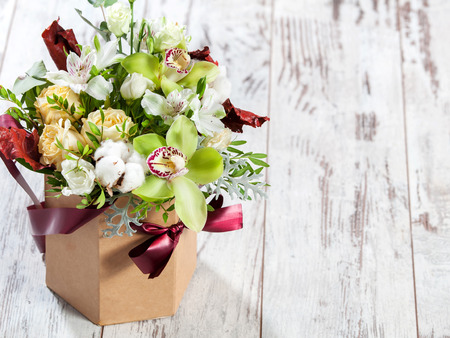 Bouquet flowers on wooden floor Фото со стока