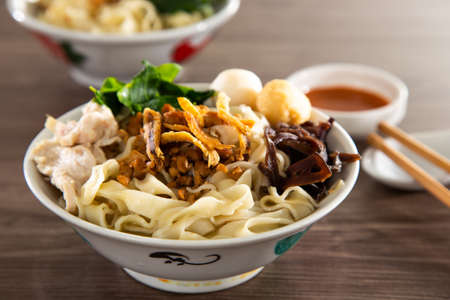 Pan mee is made with a simple flour-based dough, with anchovy broth, and topped with crispy fried anchovies, ground pork, shiitake mushrooms, and some vegetables.