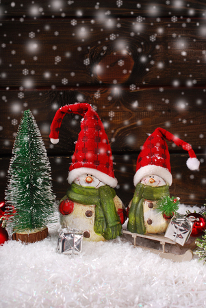 Christmas decoration with two funny santa claus figurines on wooden background Reklamní fotografie