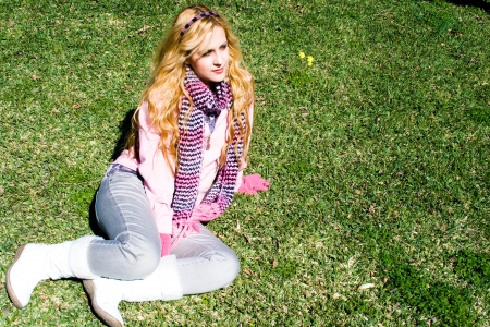 Young girl sitting on the lawn.