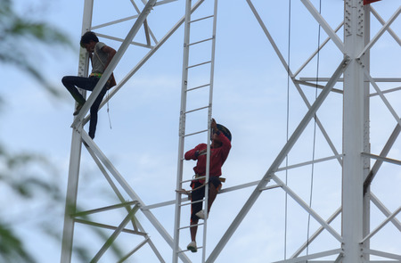 Workers demolition telephone poles due to health complaints.Mahasarakham,Thailand,July 2016