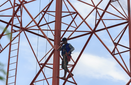 Workers demolition telephone poles due to health complaints.Mahasarakham,Thailand,July 2016