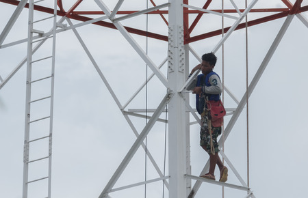 Workers demolition telephone poles due to health complaints.Mahasarakham,Thailand,July 2016