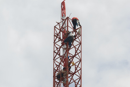 Workers demolition telephone poles due to health complaints.Mahasarakham,Thailand,July 2016