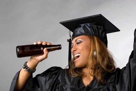 a recent graduate posing in her cap and gown holding beer bottle