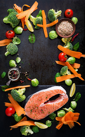 Raw Salmon Steak And Ingredients For Cooking On A Dark Background In Rustic Style Raw Salmon Steak And Ingredients For Cooking On A Dark Background In Rustic Style