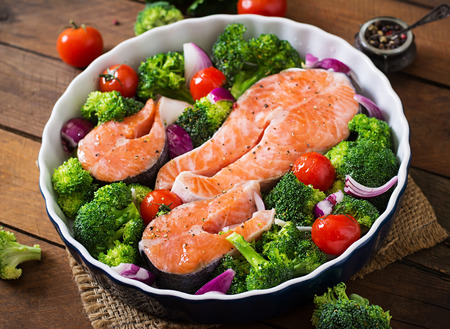 Raw Salmon Steak And Vegetables For Cooking On A Dark Wooden Background In Rustic Style Raw Salmon Steak And Vegetables For Cooking On A Dark Wooden Background In Rustic Style