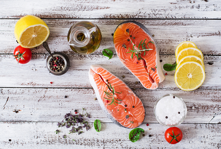 Raw salmon steak and vegetables for cooking on a light wooden background in a rustic style. Top view - 50363261