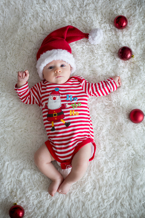 Christmas Portrait Of Cute Little Newborn Baby Boy Wearing Santa