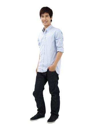 Asian male model: young man standing with hands in pockets 