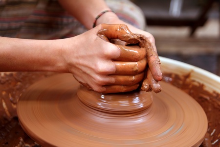 clay potter hands closeup working on wheel handcrafts pottery work - 9494255